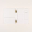 Undated quarterly daily planner with spiral binding