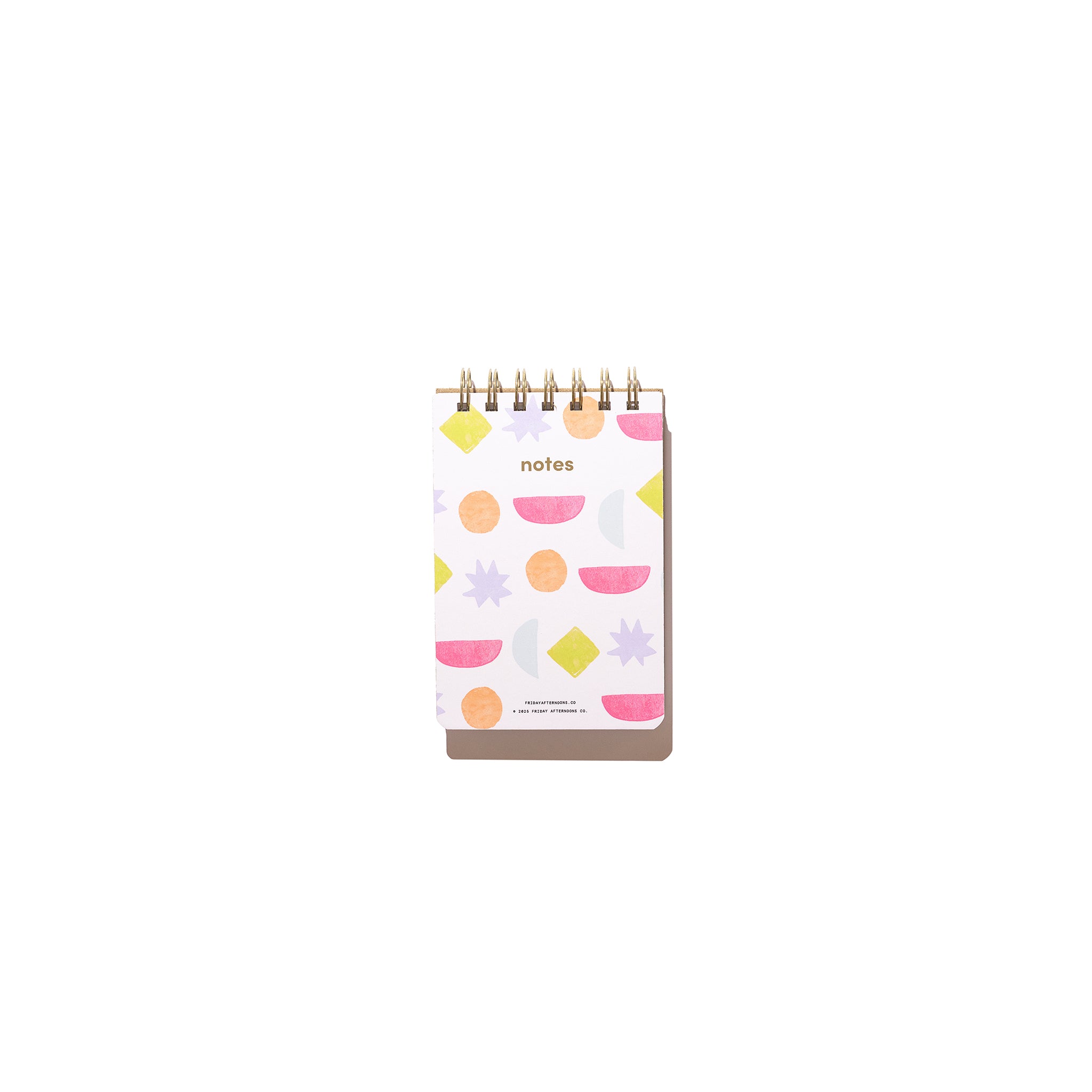 Bright Shapes Mini Memo Notebook with top spiral binding and colorful geometric cover design on a white background.