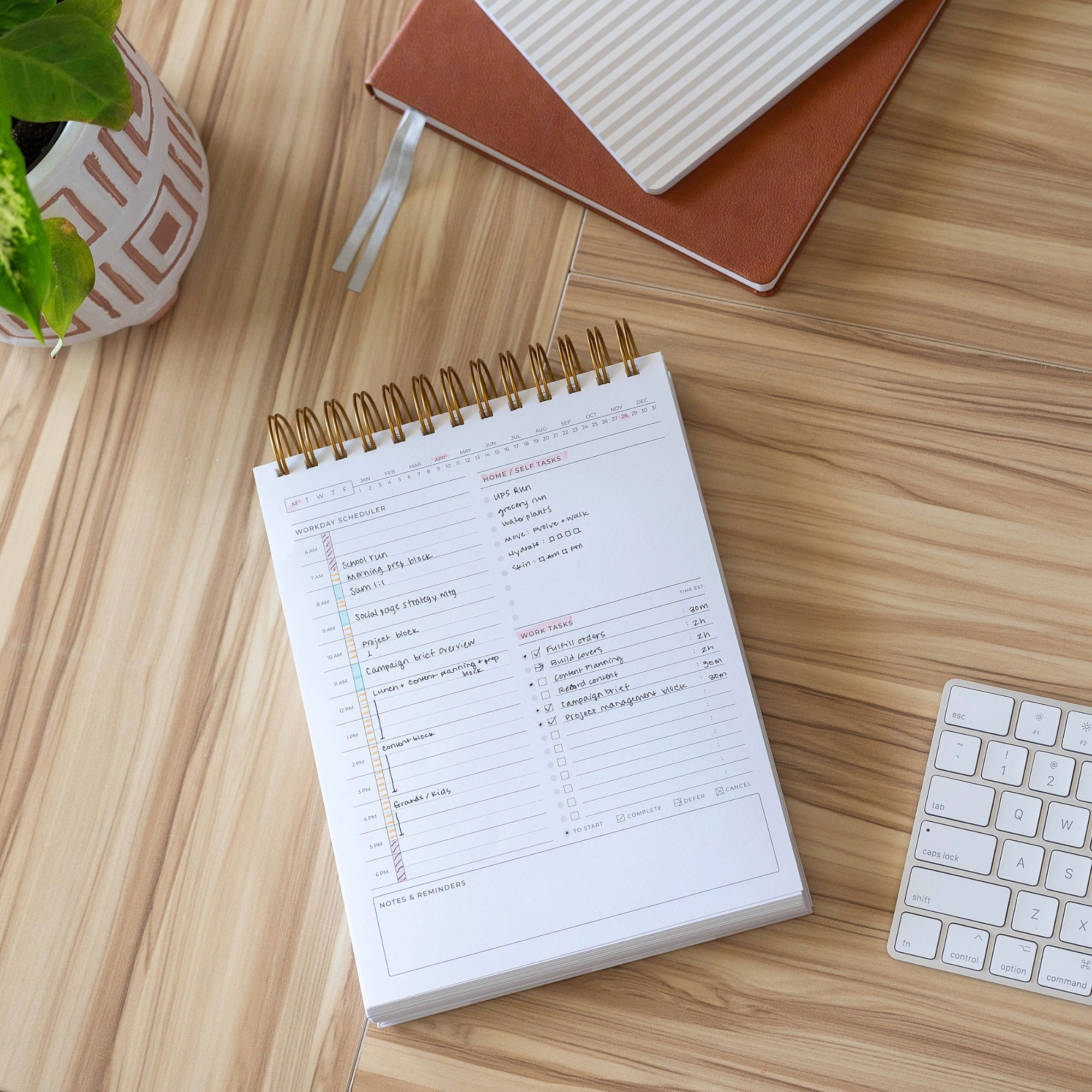 minimal workday planner with a to-do list on a wooden desk with a keyboard and plant.