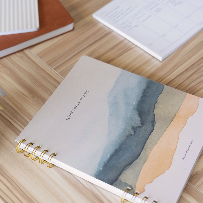 quarterly planner for goal setting and 90 day planning on organized desk by friday afternoons co