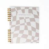 Creamy checker quarterly planner flat lay