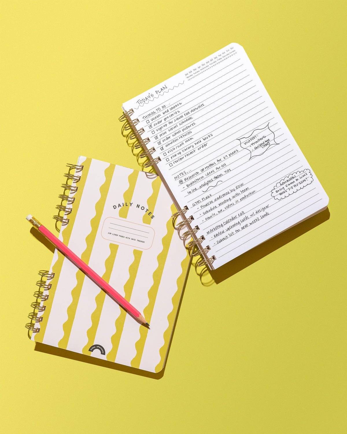 Lima Wavy Stripes Daily Notes notebook beside open lined pages with a handwritten daily plan and pink pencil on a yellow background.