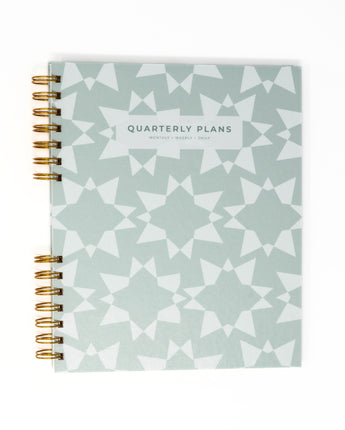 grayish green geometric stars quarterly planner flat lay