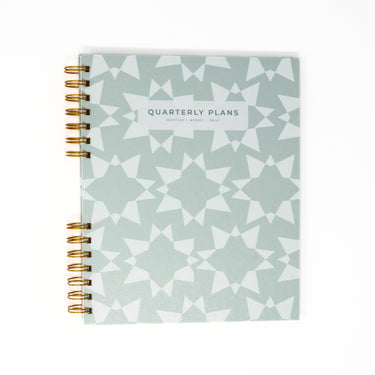 grayish green geometric stars quarterly planner flat lay