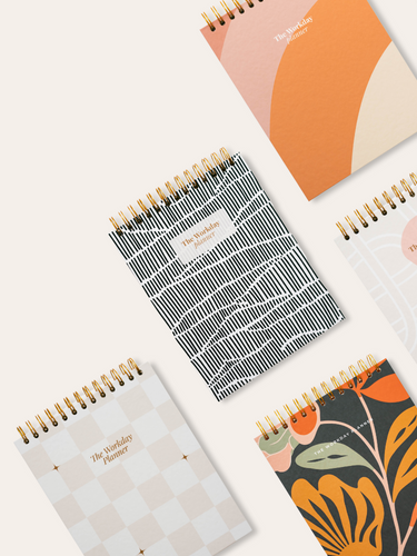 Collection of workday planners on white background