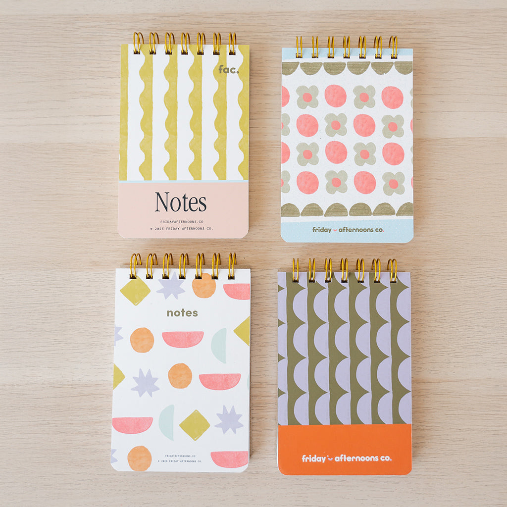 Set of patterned mini memo notebooks from Friday Afternoons Co. displayed on a light wood surface.