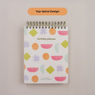 Close-up of the Workday Planner top-spiral binding and Bright Shapes patterned cover.