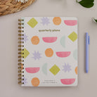 Bright Shapes 90-Day Planner styled with pen and desk accessories on a neutral background