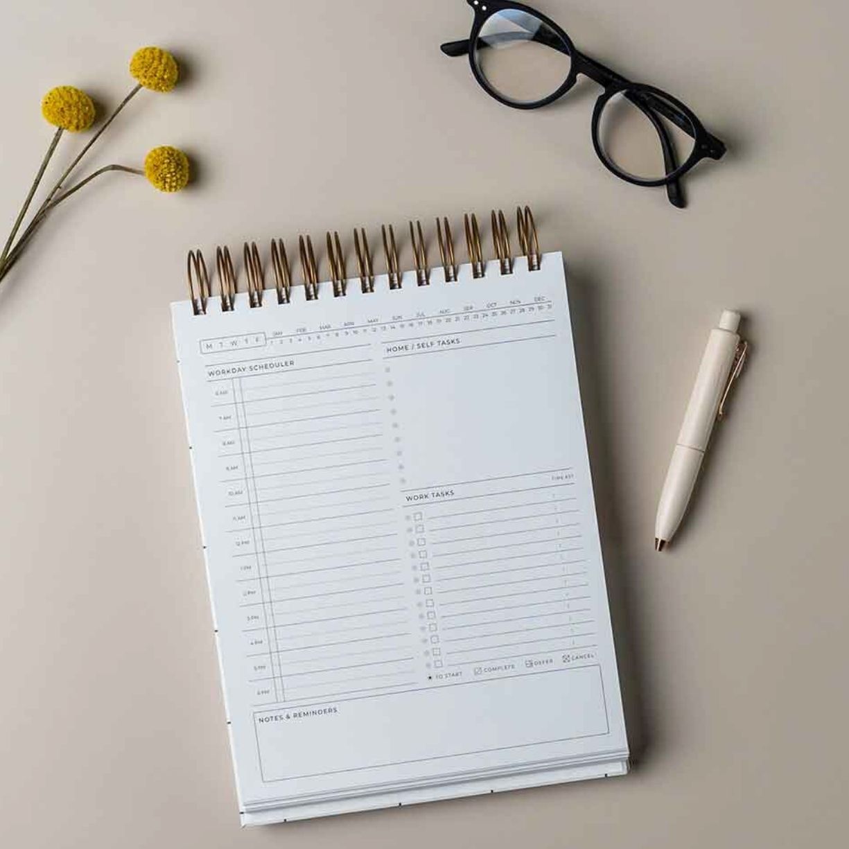 workday daily simple planner on desk with glasses and pen