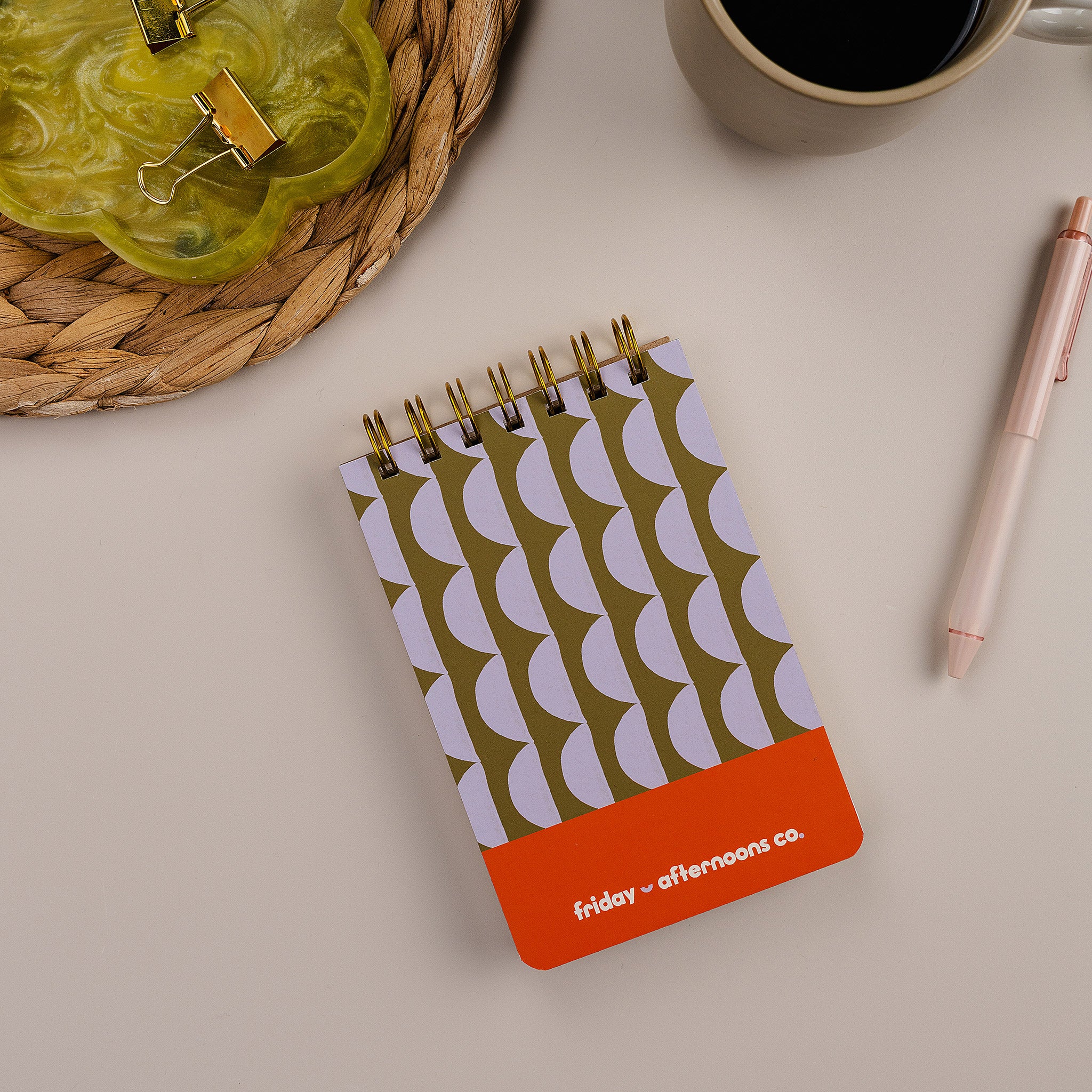 Mini Memo Notebook in Lavender Scallops  cover by Friday Afternoons Co., shown on a desk with pen and accessories.