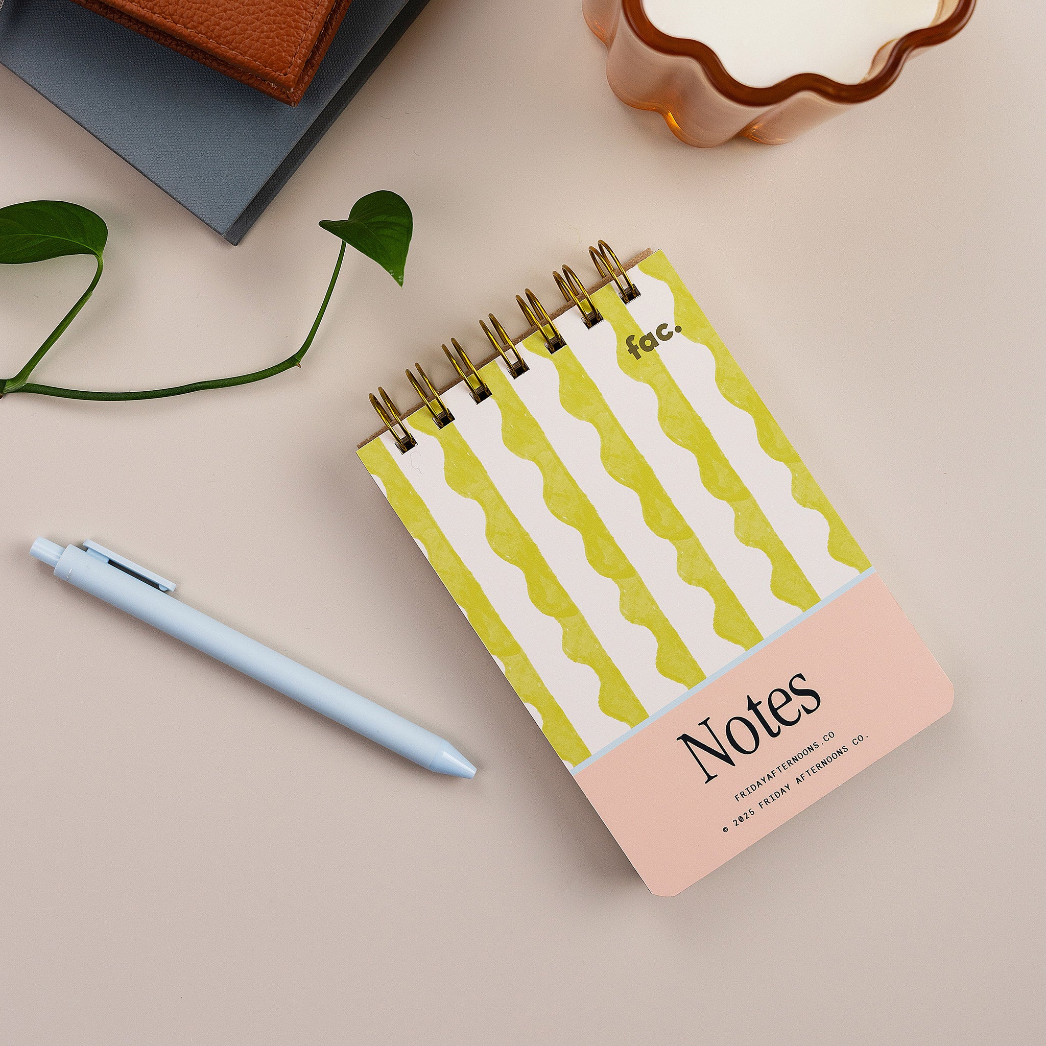 Mini Memo Notebook in Lima Wavy Stripes cover by Friday Afternoons Co., shown on a desk with pen and accessories.