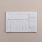 Task Track Pad weekly planner notepad shown blank with sections for each day and a task tracker column.