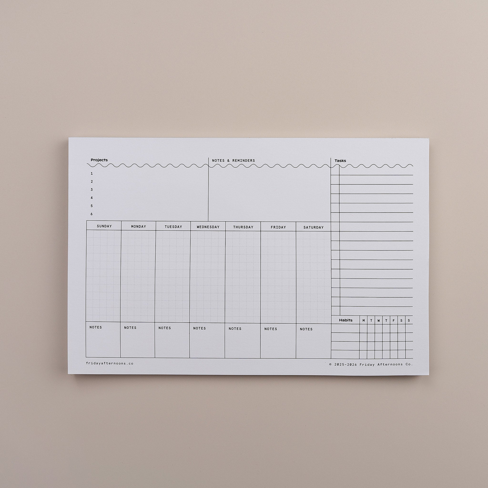 Task Track Pad weekly planner notepad shown blank with sections for each day and a task tracker column.