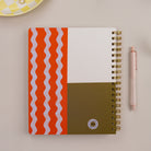 Tulip Wave Quarterly Planner styled with pen and office accessories on neutral desk surface.