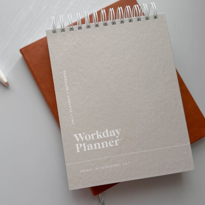 warm beige classic workday planner daily planner on desk with leather notebook